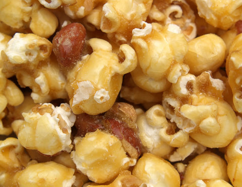 Close-up of caramel popcorn showing the texture and color of the caramel with popcorn pieces.